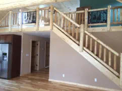 home interior with wood log railings and metal designs