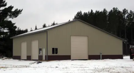 steel sided shed with two large doors on the side and one in front