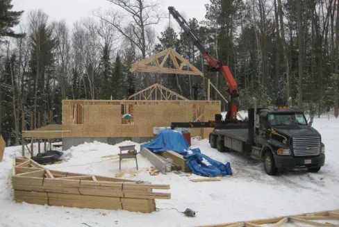 house frame being built with crane in Northern Wisconsin