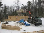 house frame being assembled with crane